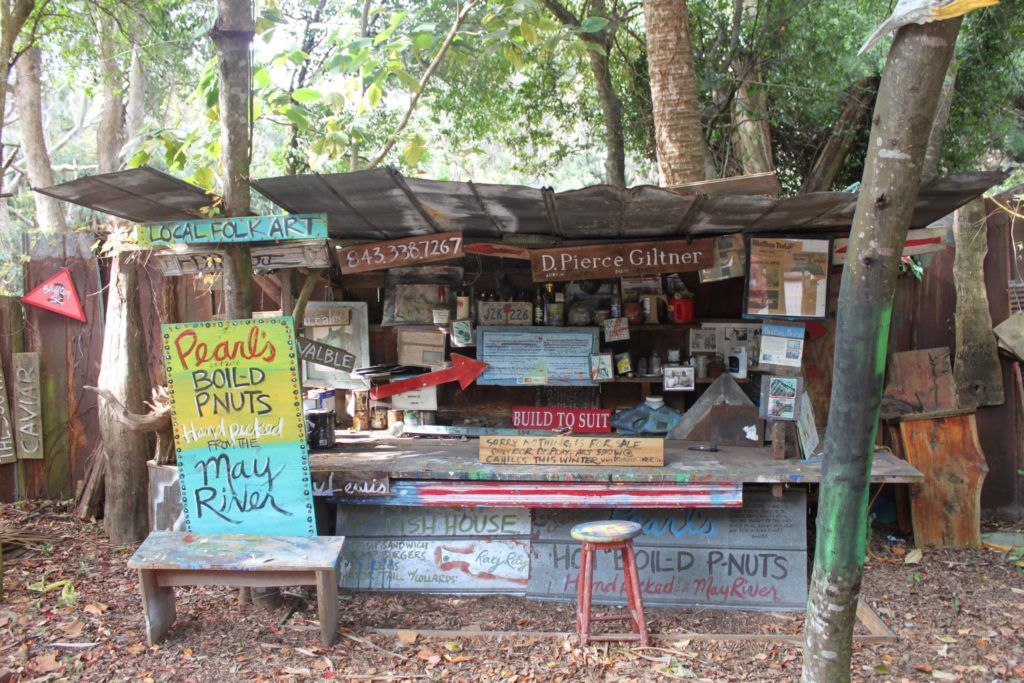 A tin shack holds colorful signs for boiled peanuts